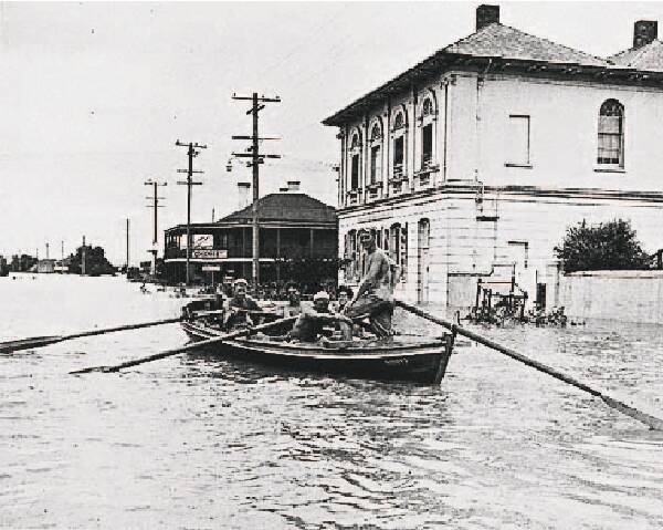 RESCUE: A surfboat moving through East Maitland in the 1955 flood.