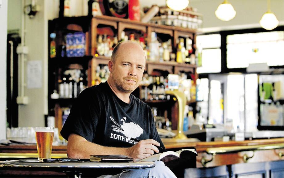 THIRSTY WORK: Damien Slevin of Waratah sketches the Kent Hotel over a beer.   Picture: Max Mason-Hubers