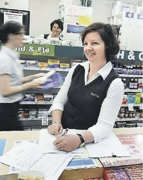CHOICE: Annie Fullerton at Elermore Vale Pharmacy writing a sick certificate.- Picture by Natalie Grono