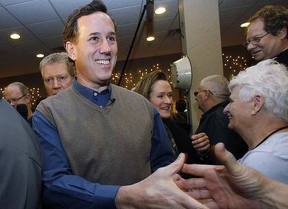 Republican presidential candidate and former Pennsylvania Senator Rick Santorum shakes hands during a meet and greet campaign stop in Iowa.