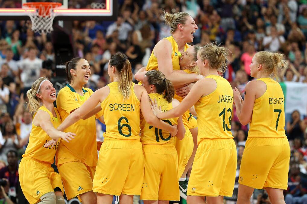 LONDON, ENGLAND - AUGUST 11:   Suzy Batkovic (C) #8 and Lauren Jackson #15 of Australia embrace as they celebrate with their teammates after they won 83-74 against Russia during the Women's Basketball Bronze Medal game on Day 15 of the London 2012 Olympic Games at North Greenwich Arena on August 11, 2012 in London, England.  (Photo by Christian Petersen/Getty Images)