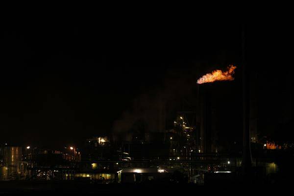 FLAMES: The plume of fire at Orica's Kooragang Island plant last night. - Picture by PETER STOOP