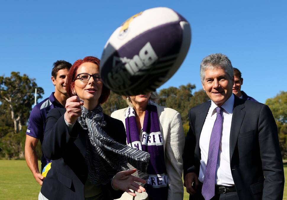 OUT WEST: Prime Minister Julia Gillard handballs a football  in Perth yesterday. Earlier in the day she had a meeting with former California governor Arnold Schwarzenegger 