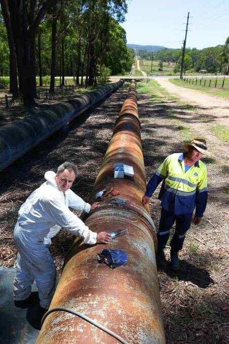 FIXED: Hunter Water maintenance employees Steven Wallis and Dale Collins were working on the pipeline near Brandy Hill yesterday.  Picture: Peter Stoop