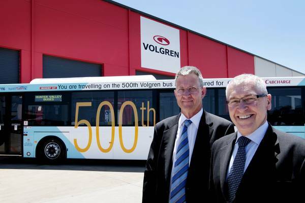 BETTER DAYS: In November last year  the Volgren factory at Tomago produced its 500th bus.  Jim Glasson, CEO of ComfortDelGro Cabcharge, left, took  delivery of his bus from Peter Dale, Managing Director of Volgren.