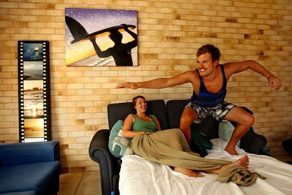 NO GREY SUITS: German backpackers Miri Scherer, 24, and Felix Hausler, 23, surfed into Merewether. –  Picture by Simone De Peak