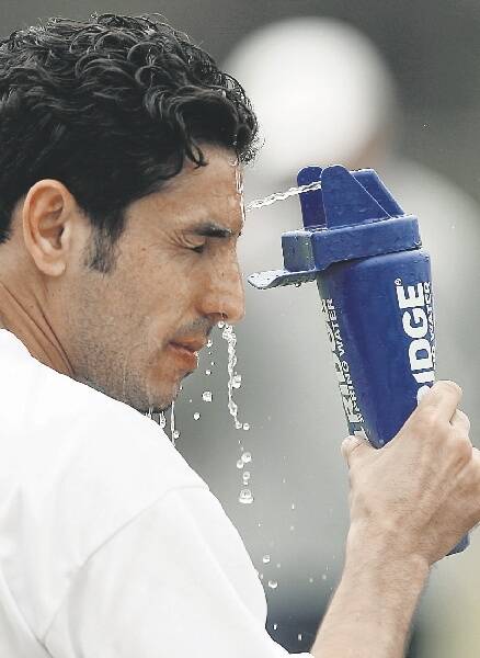 THIRSTY WORK: Ali Abbas cools down at Jets training yesterday.- Picture by Ryan Osland
