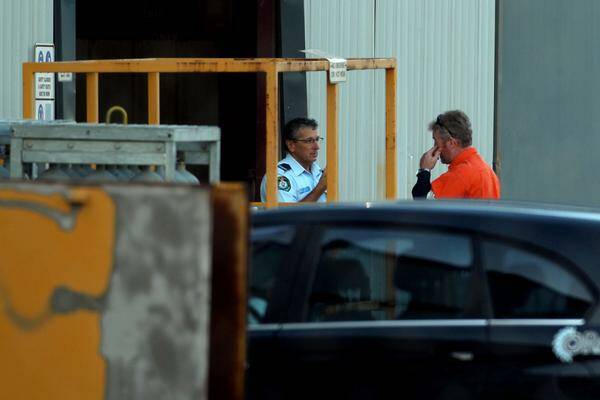INVESTIGATION: Police talk to an employee at ResCo yesterday. - Picture by Simone De Peak