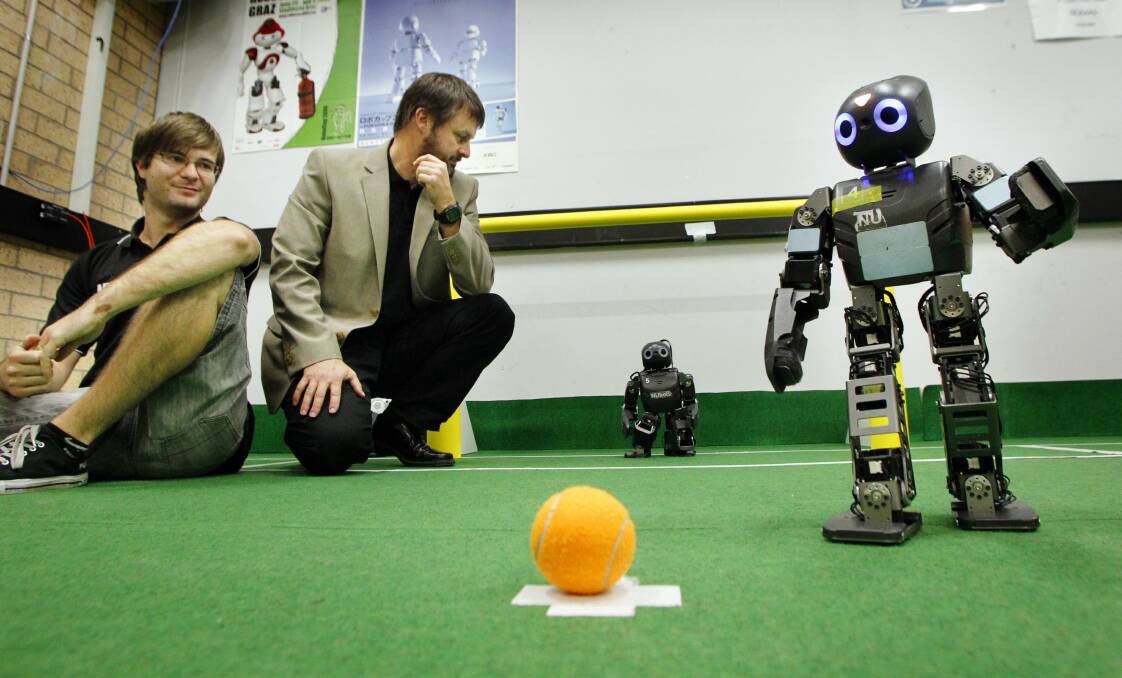 HUMANOIDS: Josiah Walker and Professor Stephen Chalup, with soccer-playing robots for Robocup 2013. Picture: Max Mason-Hubers