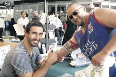 FAN: Former Knight Andrew Johns signs Chard Smith's arm below the Knights tattoo.- Pictures by Natasha Halverson
