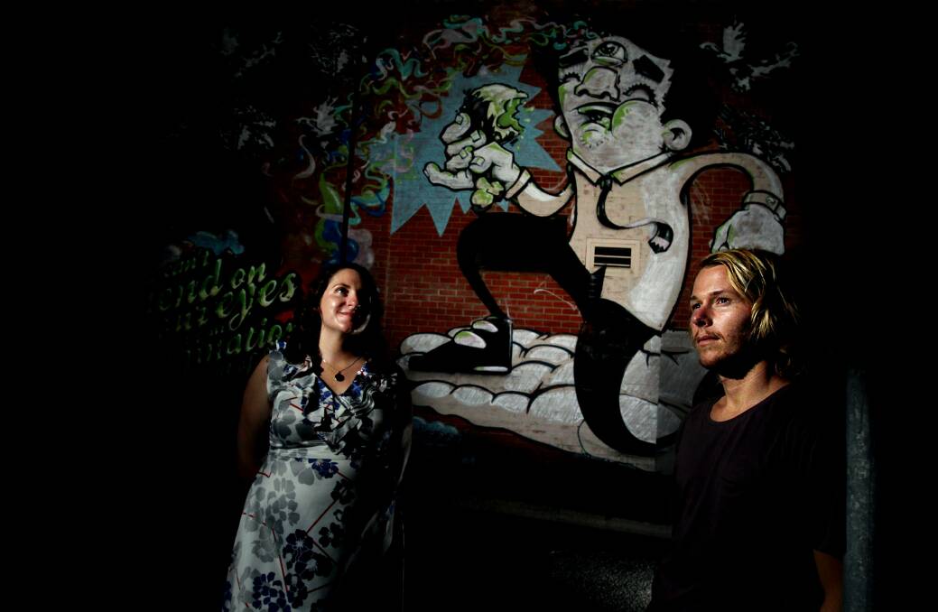STYLE: Simone Sheridan with artist Alex Ball in front of his Morgan Street mural. Pictures: Simone De Peak
