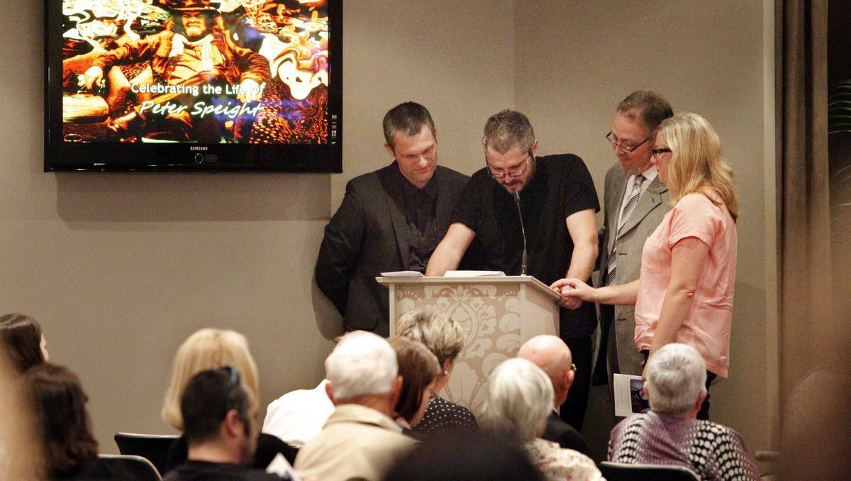 TRIBUTE: Artist Nigel Milsom, second from left, speaks at the funeral. Picture: Max Mason-Hubers