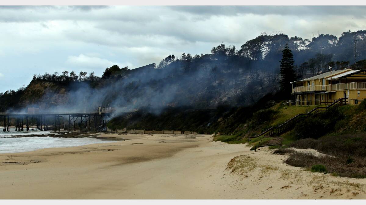 WORTH SAVING: The aftermath of fire at Catherine Hill Bay where the jetty smoulders.  Picture: Simone De Peak