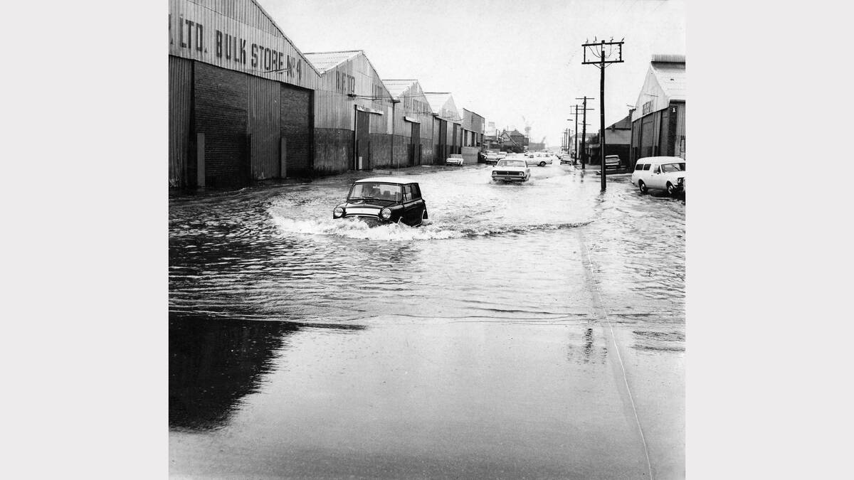 Wickham Local flooding of streets in wickham Cars drive through flooded street in Wickham Newcastle Morning Herald 2-7-1976 