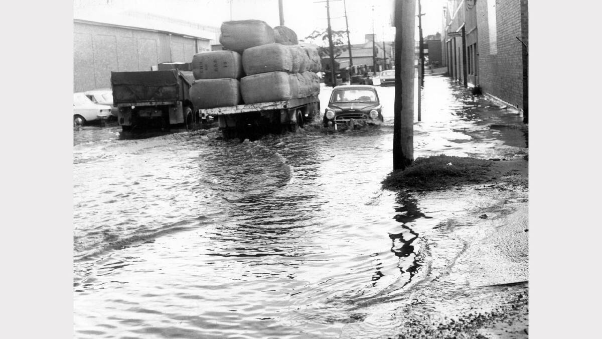 Wickham Local flooding of streets in wickham Cars drive through flooded street in Wickham Newcastle Morning Herald 2-7-1976 