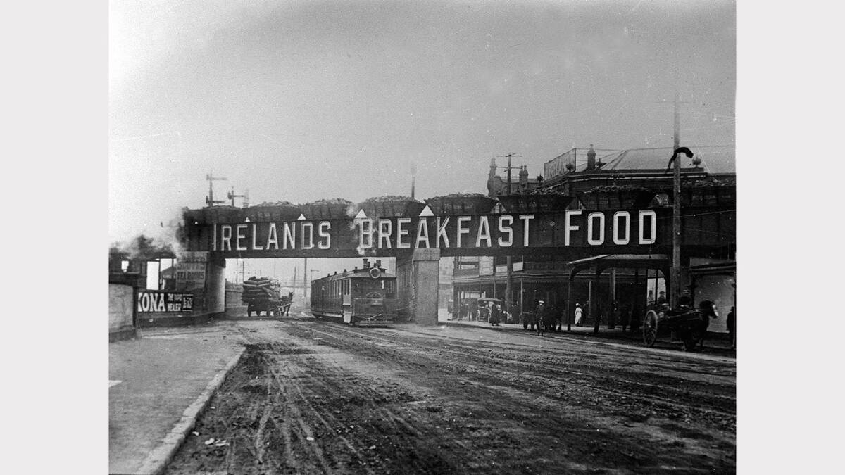 ARCHIVAL REVIVAL 1900s: Photographs from the Newcastle Herald's files. Iron Bridge spanning Hunter Street, advertising Ireland's Breakfast Food. 