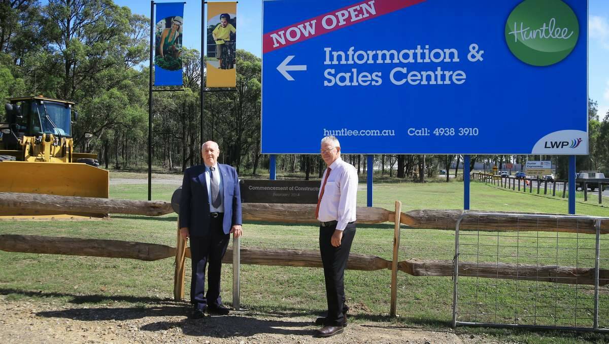  Singleton Mayor John Martin and Cessnock Mayor Bob Pynsent with the sign unveiled on Tuesday to officially mark the start of work on Huntlee.  Picture Peter Stoop