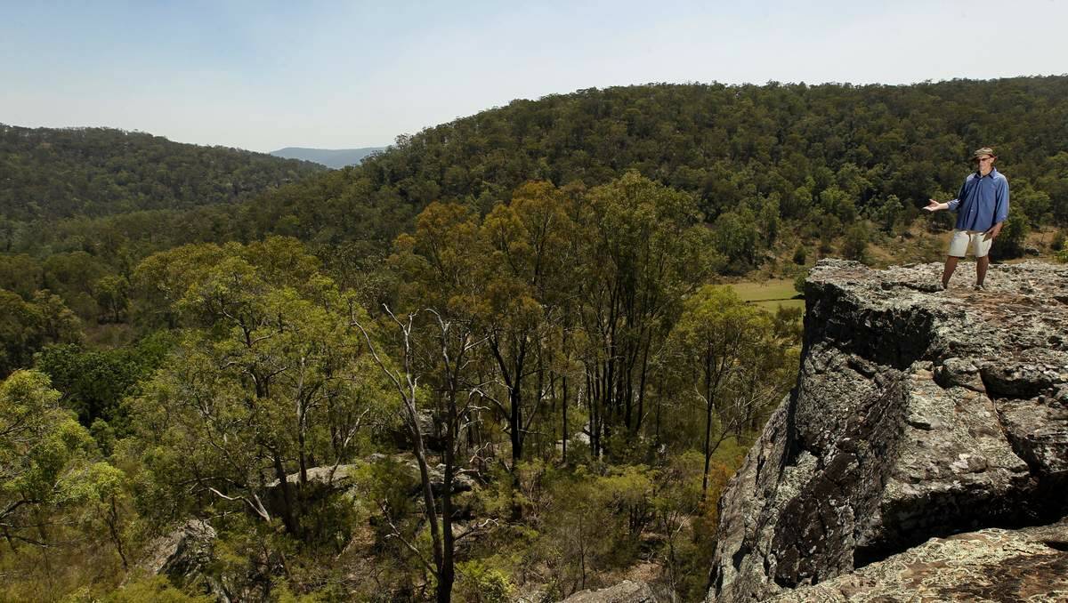 PRISTINE  LANDSCAPE:  Wollombi artist and resident Paul Selwood admires the views of Yengo National Park from his Wollombi property. Picture: JONATHAN CARROLL