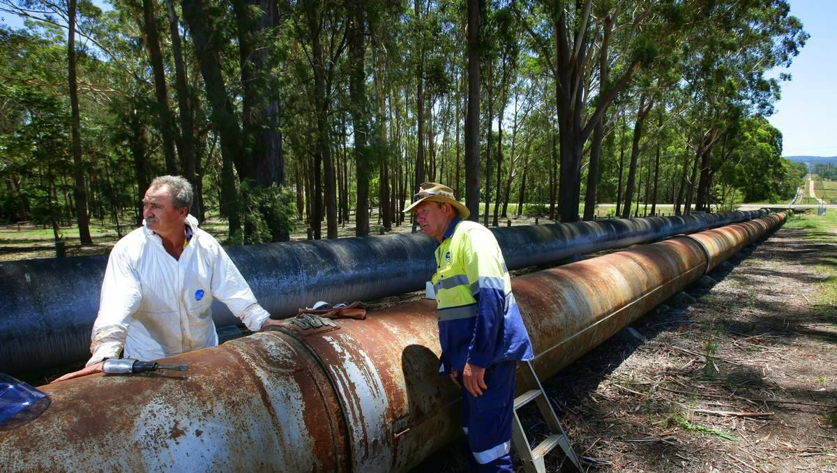 FIXED: Hunter Water maintenance employees Steven Wallis and Dale Collins were working on the pipeline near Brandy Hill yesterday.  Picture: Peter Stoop