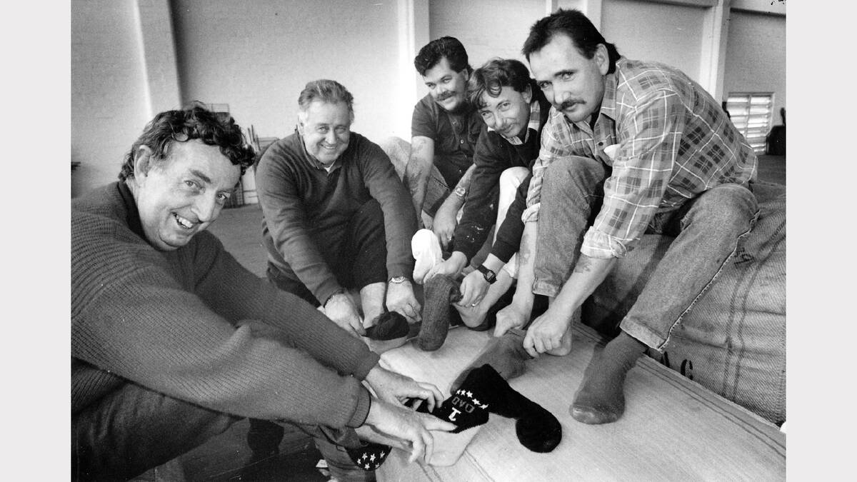 Tom Tower manager with storemen Eddie Scott, Allan Osbourne, Geoffrey Fowler and Joe Przezdzik pull on wool socks to promote the fleece.