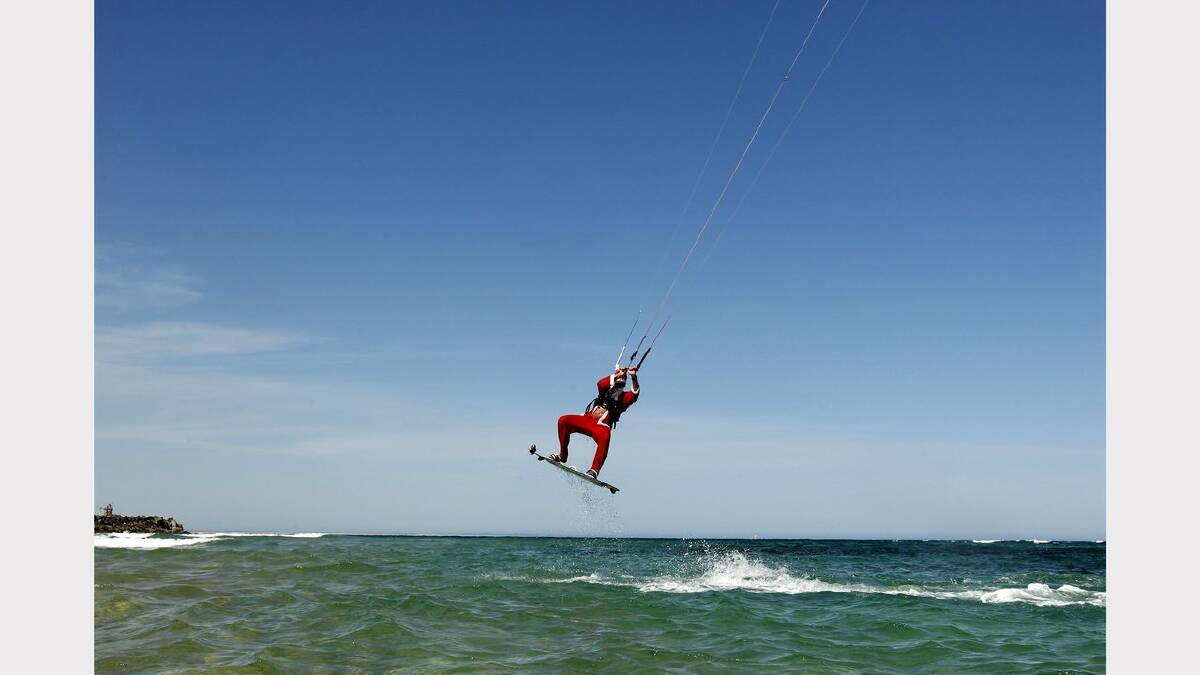 Kite-surfing Santas at Nobbys Beach, Newcastle.  Craig Shales in action. Picture Jonathan Carroll. 