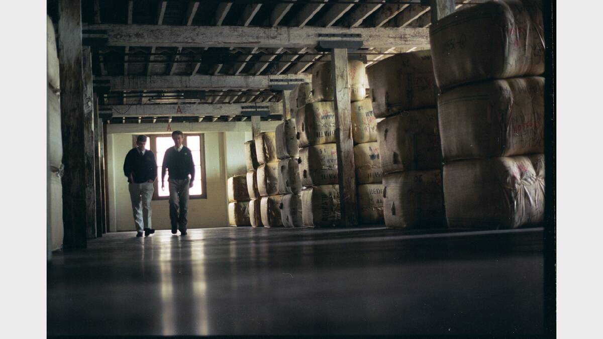 Tom Towers, chairman of the Newcastle Wool Brokers Trade Committee (right) and Bob Walker, manager of Schute Bell Newcastle walking through a wool store in Maryville in 1996. 