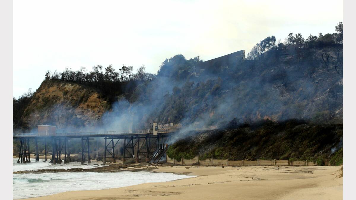 WORTH SAVING: The aftermath of fire at Catherine Hill Bay where the jetty smoulders.  Picture: Simone De Peak