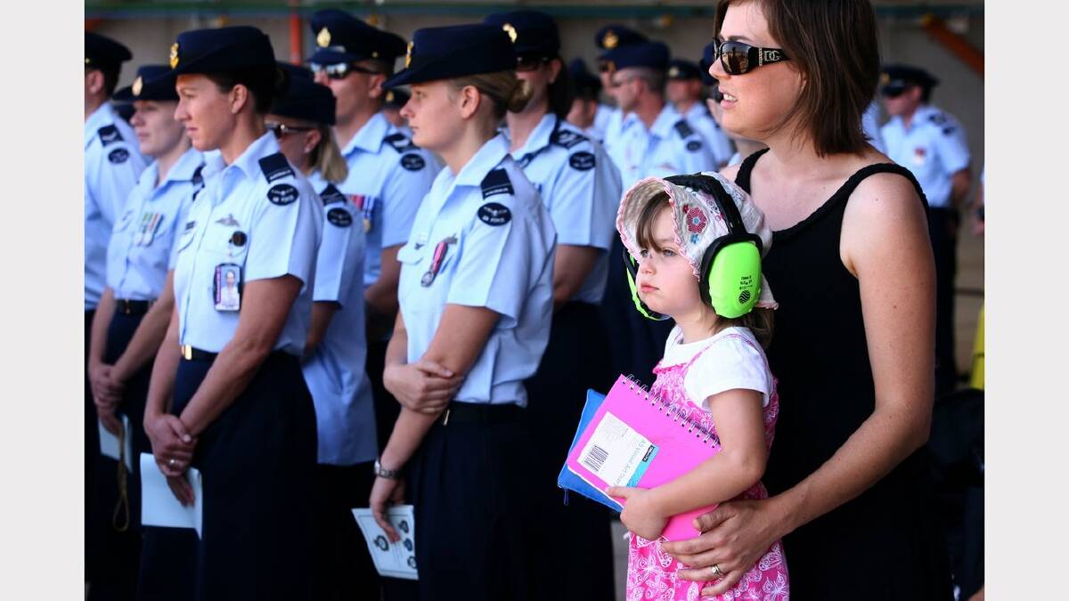 Williamtown RAAF base hosts 70th anniversary of 41, 42 and 44 wings. Suzanna Andric and daughter Lillian (3) watch the proceedings. Suzanna's husband, Leading Aircraftman Ed Andric, was in the parade.  Picture Brock Perks