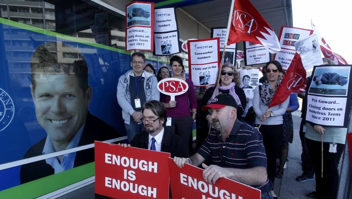 DOCS workers protest cuts outside Andrew Cornwell's electoral office in Charlestown oN Tuesday. In front (from left) are Paul James (PSA regional organiser) and Matt Ford (regional delegate, community services). Picture: Brock Perks
