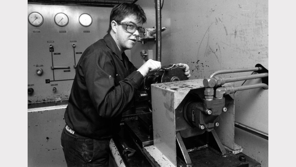 Apprentice fitter and machinist Craig McLennon from Cessnock working in the hydraulic testing room, Alcan aluminum smelter at Kurri Kurri on July  19. 1994. Picture: Ken Robson  