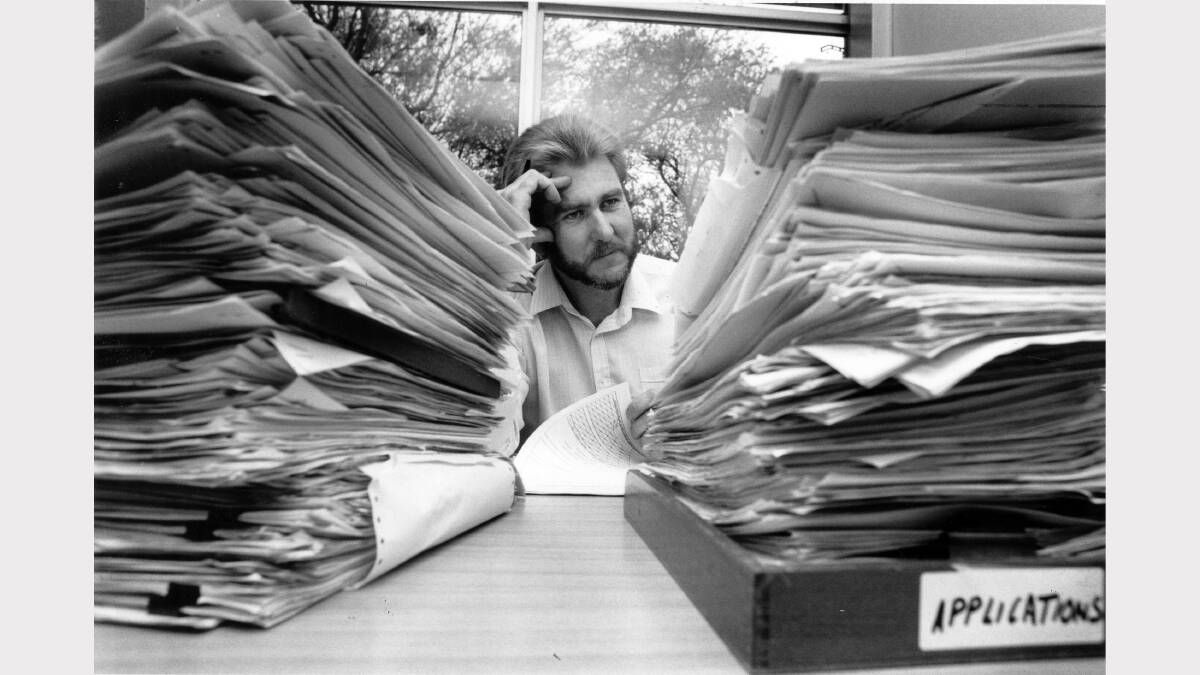 Alcan aluminium smelter Kurri Kurri. Personnel officer Les Jordan with the piles of applications for apprenticeships.  November 20, 1991. Picture Waide Maguire