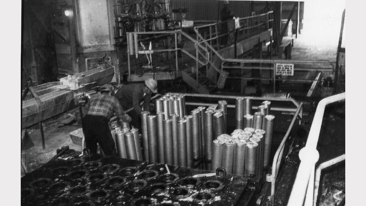 The casting plant at the Alcan aluminium smelter at Kurri Kurri. Extrusion ingots being made on the direct chill machine, where rapid solidification takes place through the water cooled moulds on April, 16, 1979. 