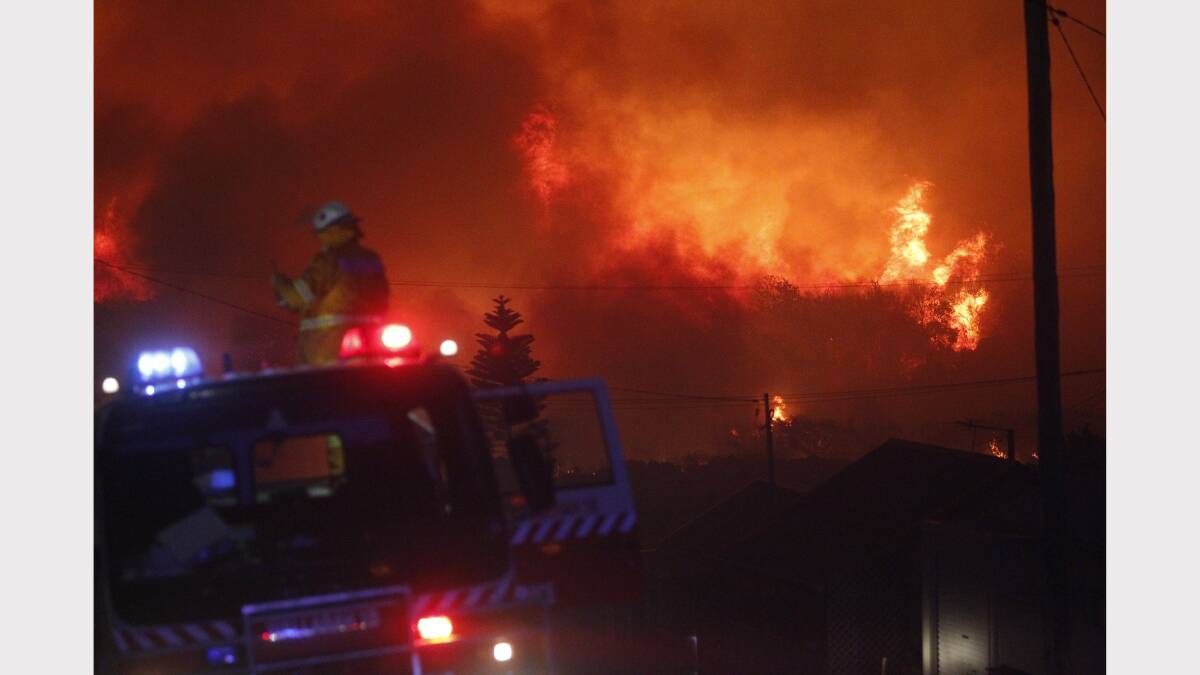 Scenes from the fire at Catherine Hill Bay on Thursday night. Pictures by Jonathan Carroll