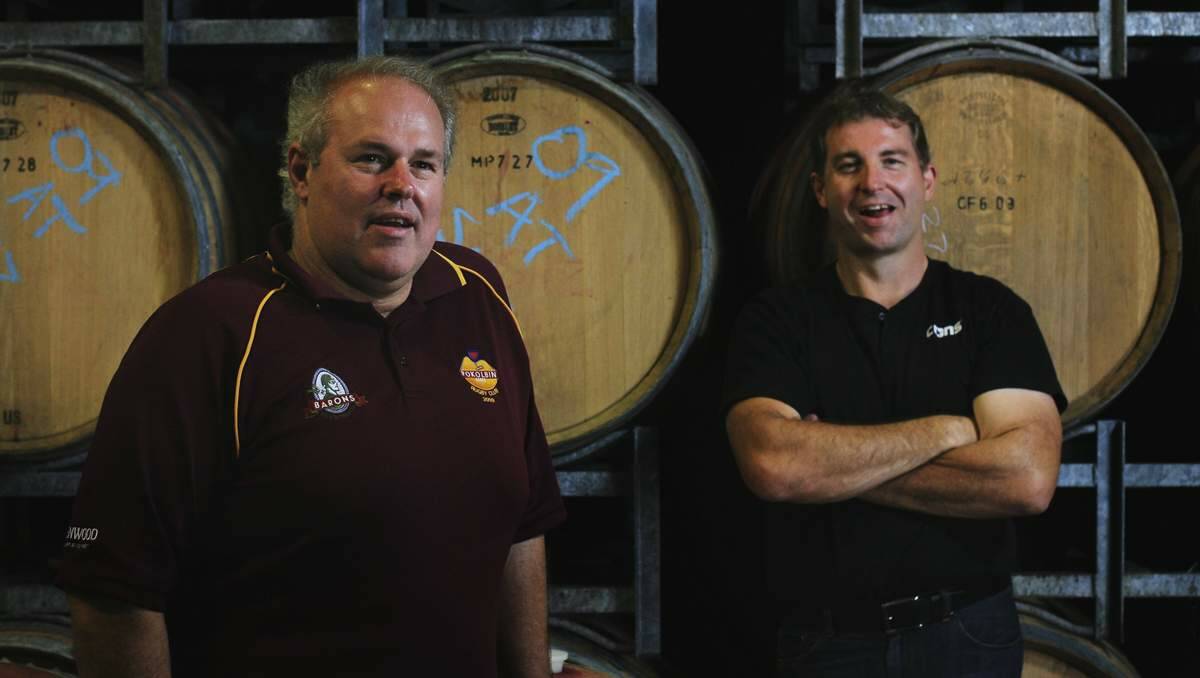 ON THE MOVE: Rhys and Garth Eather among the wine barrels. Meerea Park Wines tasting and sales operation is due to reopen at Tempus Two in a few weeks’ time. Picture: Peter Stoop