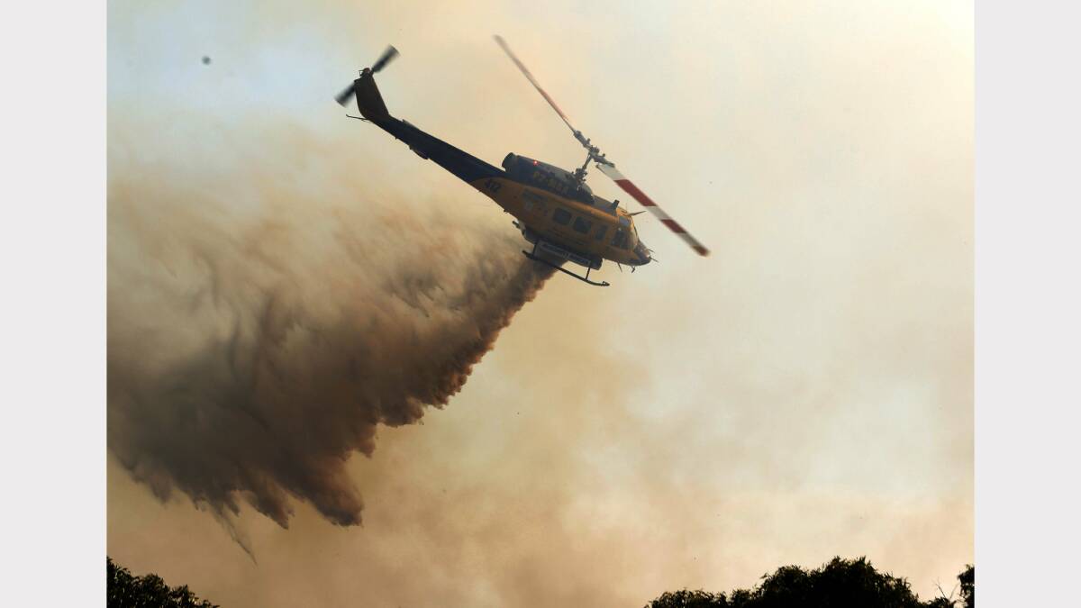 A helicopter doing waterbombing at the Dudley-Redhead fire.  Picture by Darren Pateman