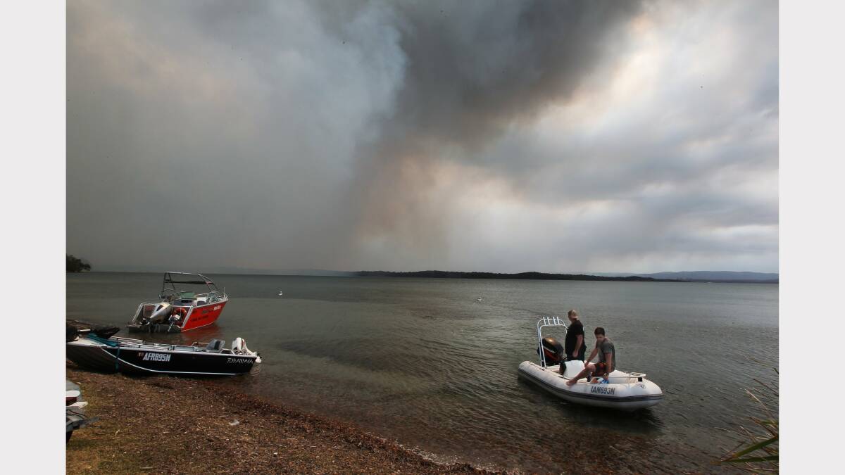 Scenes from the fires at Catherine Hill Bay and Chain Valley Bay on Friday. Photo by Phil Hearne