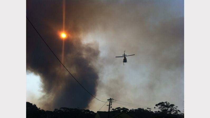 Waterbomber in action over the Awabakal Reserve near Dudley. Picture by Matt Kelly