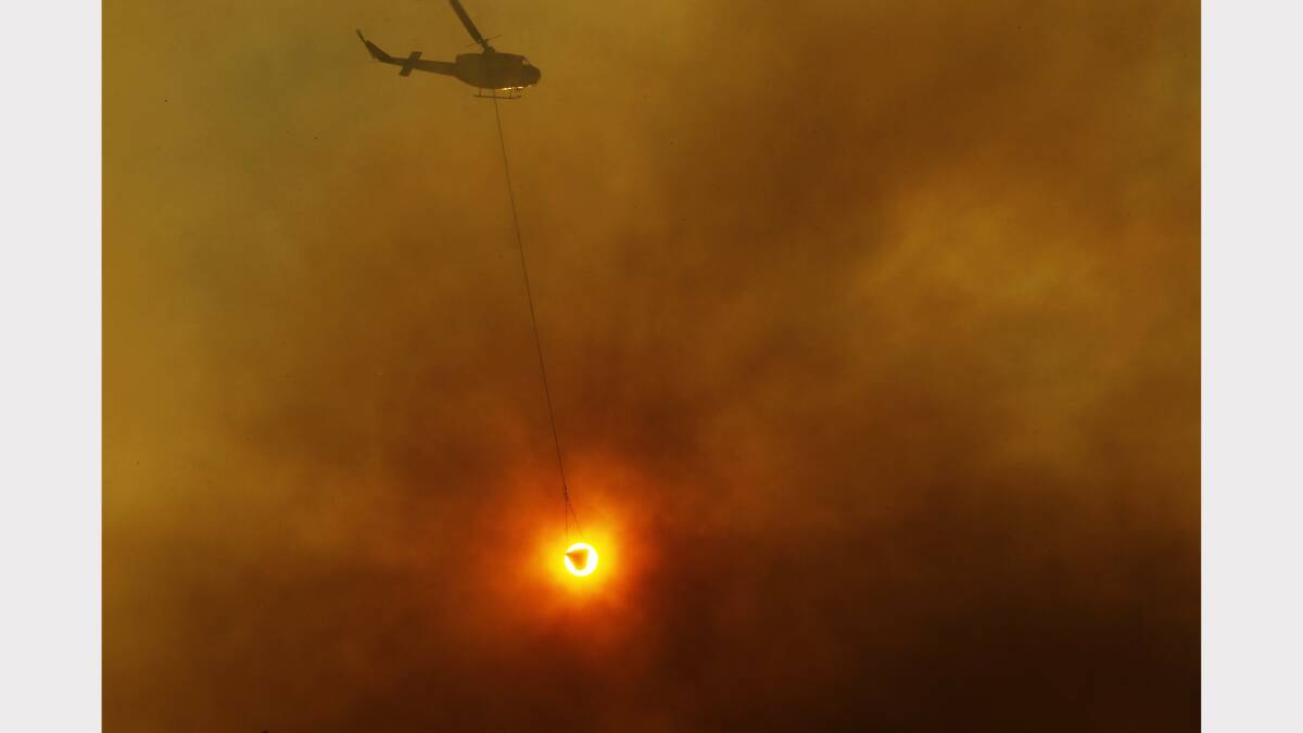 A helicopter water bomber in action at the Dudley-redhead fire. picture by Max Mason-Hubers.