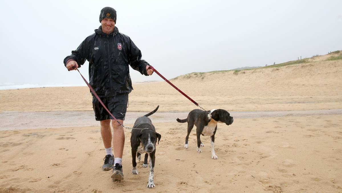 REGULAR VISITOR: Jeremy Hickmans, of Valentine, takes his dogs, Yorkie and Jafa, for a stroll at Redhead beach.  Picture: Dean Osland