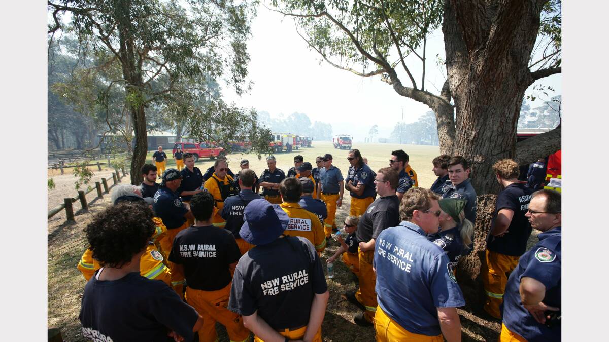 Rural Fire Fire service members prepare for action at Minmi. This is the staging area Minmi Sportsground next to the evacuated public school  Picture by Peter Stoop