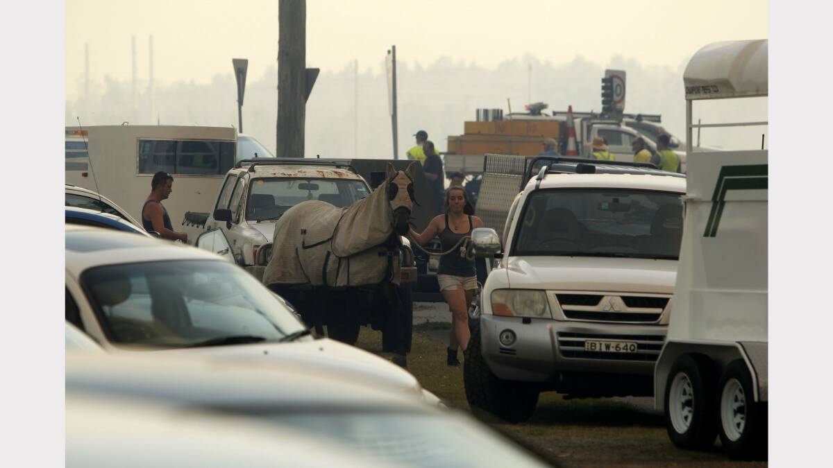 CHAOS: Scenes from Williamtown as a fire breaks containment lines. Pictures by Jonothan Carroll