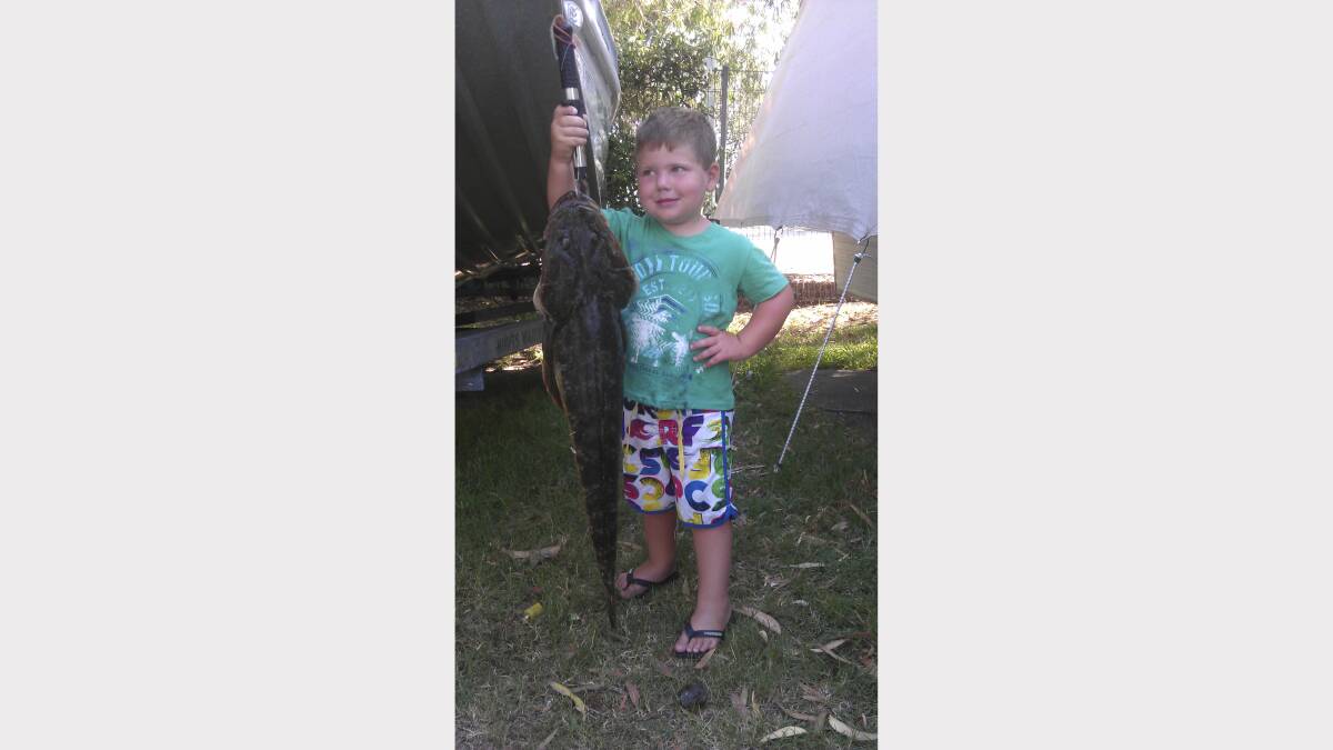 PROUD: Three-year-old Hugh Thomas from Kurri Kurri with a 85cm flathead he hook when live baiting for kingfish in Nelson Bay. 