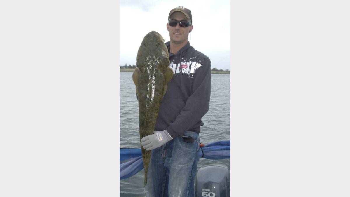MONSTER: Andrew Linton shows off his 114cm flathead hooked in Newcastle Harbour.
