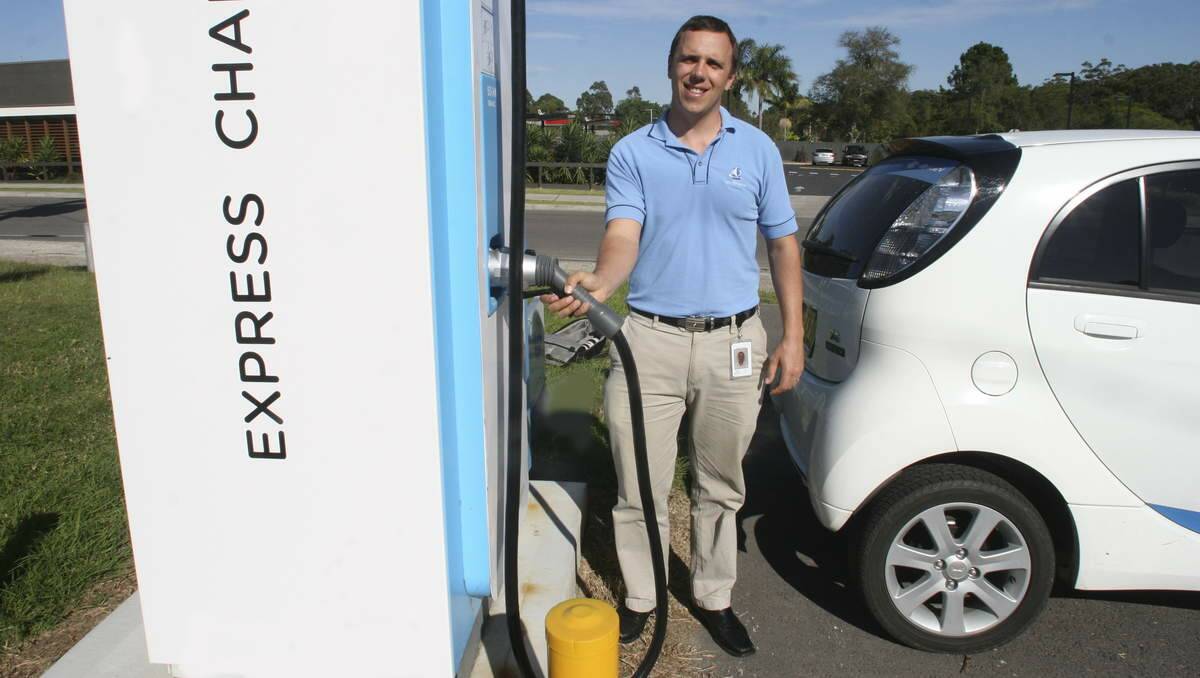 PLUGGED IN: Lake Macquarie City Council's senior sustainable living officer, James Giblin, about to charge the council's electric car at the Ausgrid charging bay at Morisset on Monday. Picture: David Stewart