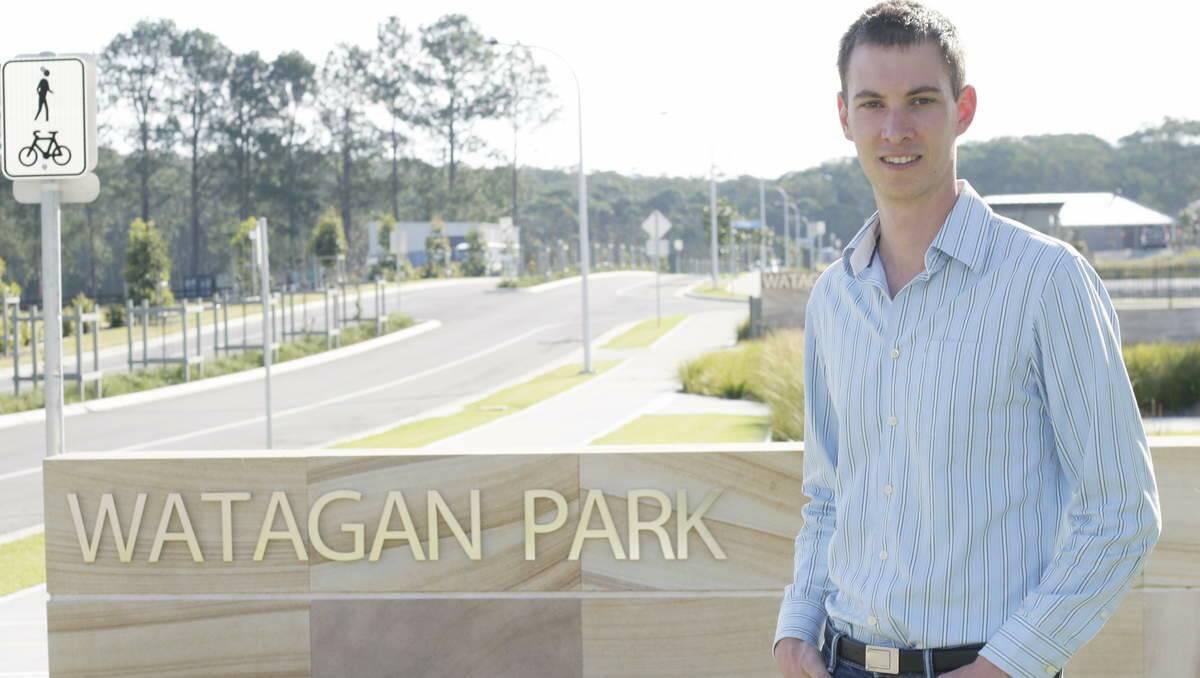 NOW SELLING: Braden Johnson at the entry to Watagan Park, where the first 80 lots of the planned 2500-lot release have been purchased. Pcitre: David Stewart