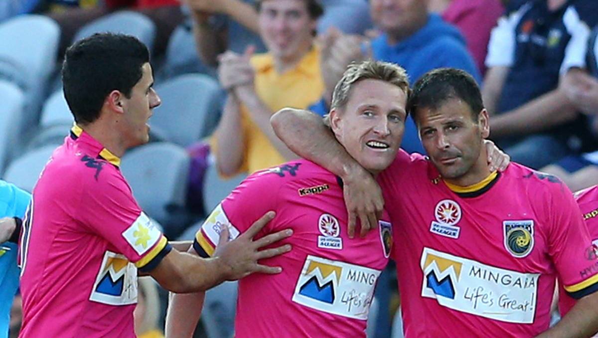 GOAL: Daniel McBreen, centre, celebrates with teammates during a 2012 A-League match.