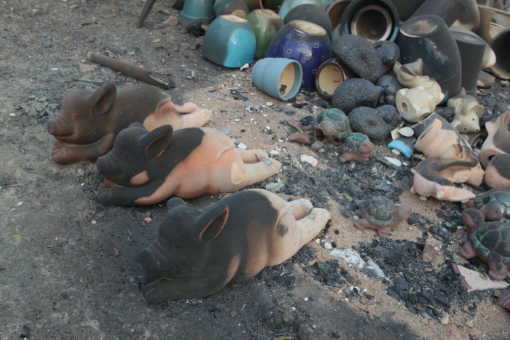 Scorched pottery pigs at the Big T roadhouse, alongside the Big Prawn. Picture: Phil Hearne