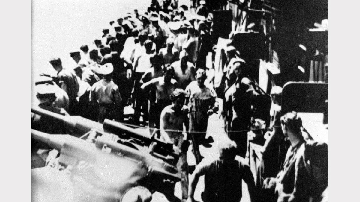 RESCUE: Survivors from the Iron Knight on the deck of a French ship.