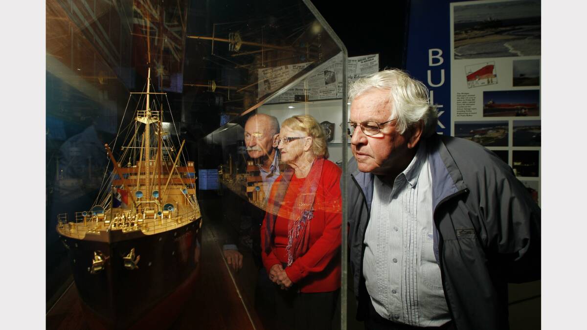 REMEMBERING: Ken Iredale, of Fletcher (centre) with Dawn Taylor, of Speers Point, and Ray Sauvan, of Gosford, at Newcastle Maritime Museum with an original model version of the Iron Knight. Picture: Max Mason-Hubers