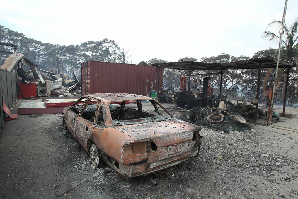 A burnt-out garage on the Pacific Highway. Picture: Phil Hearne
